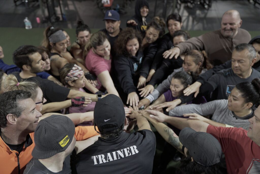 group fitness class huddle after boot camp workout